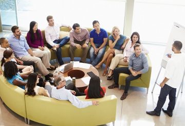 Businessman Making Presentation To Office Colleagues